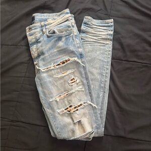 AMIRI Light Blue Distressed Skinny Jeans with Leopard Underlay